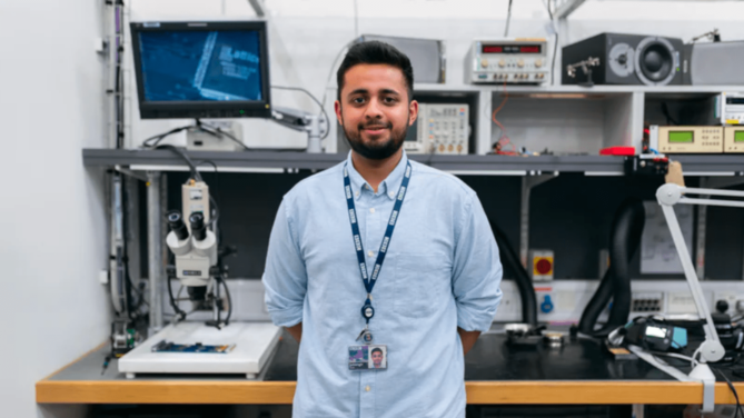 Scientist standing in front of equipment